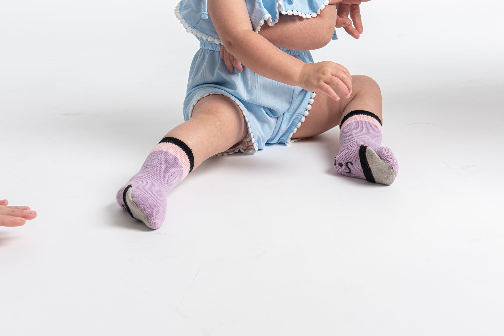 Peekaboo baby gripper socks that allows you to cover or uncover your toes